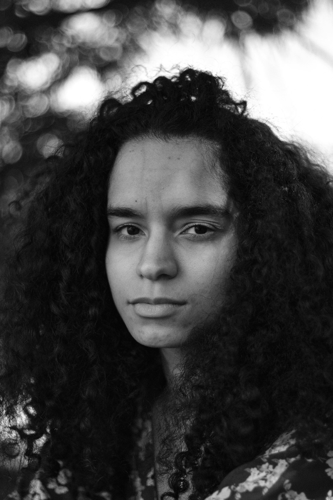 Portrait of a woman colourist with curly dark hair