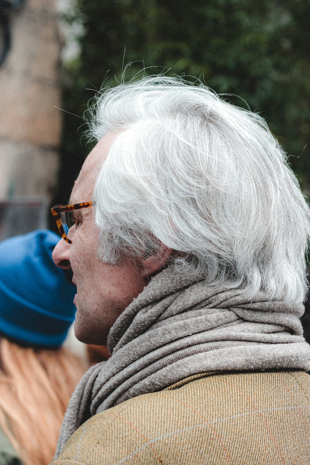 Portrait of a man sound designer with grey hair and round glasses