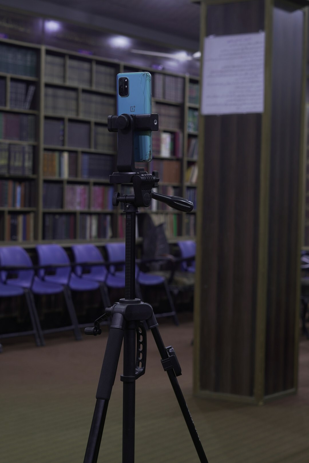 Professional cinema camera and lenses on a tripod in an equipment room