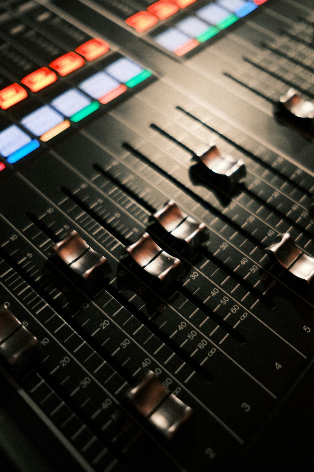 Audio mixing console with faders in a sound design studio