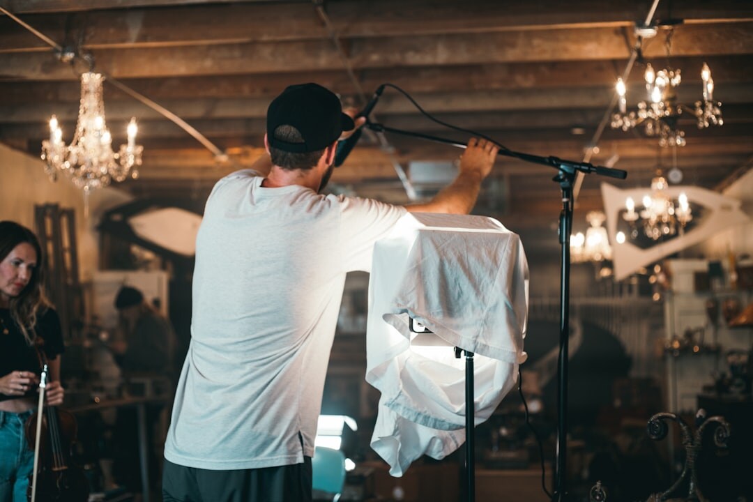 cinematographer adjusting lights on film set